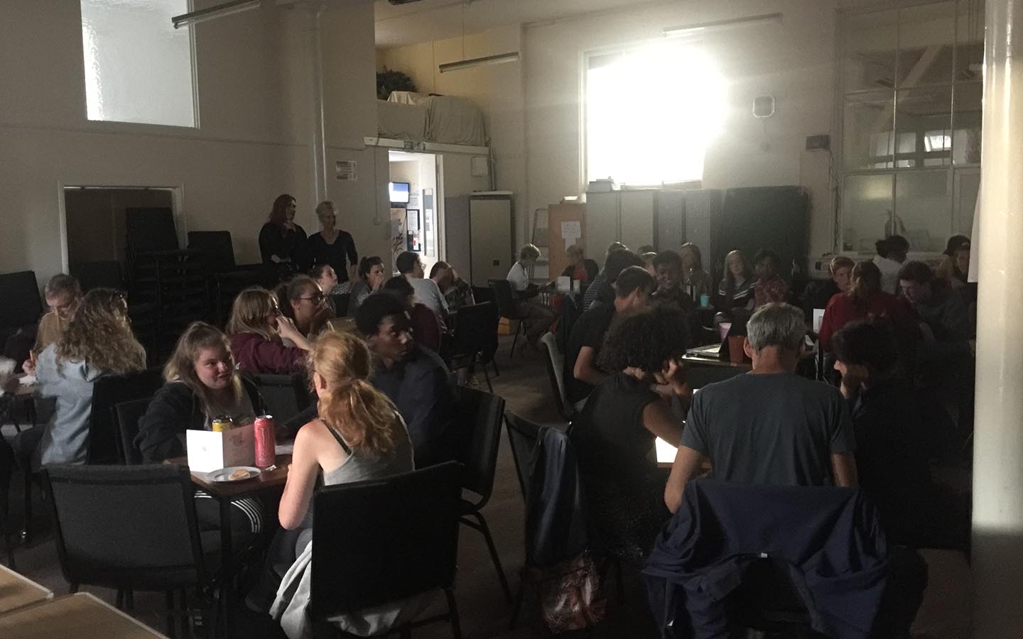 people sat round tables at Team One's charity quiz night
