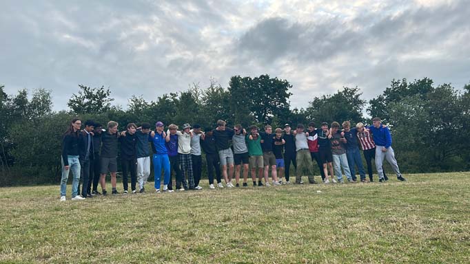  A large group of boys stoop arm in arm