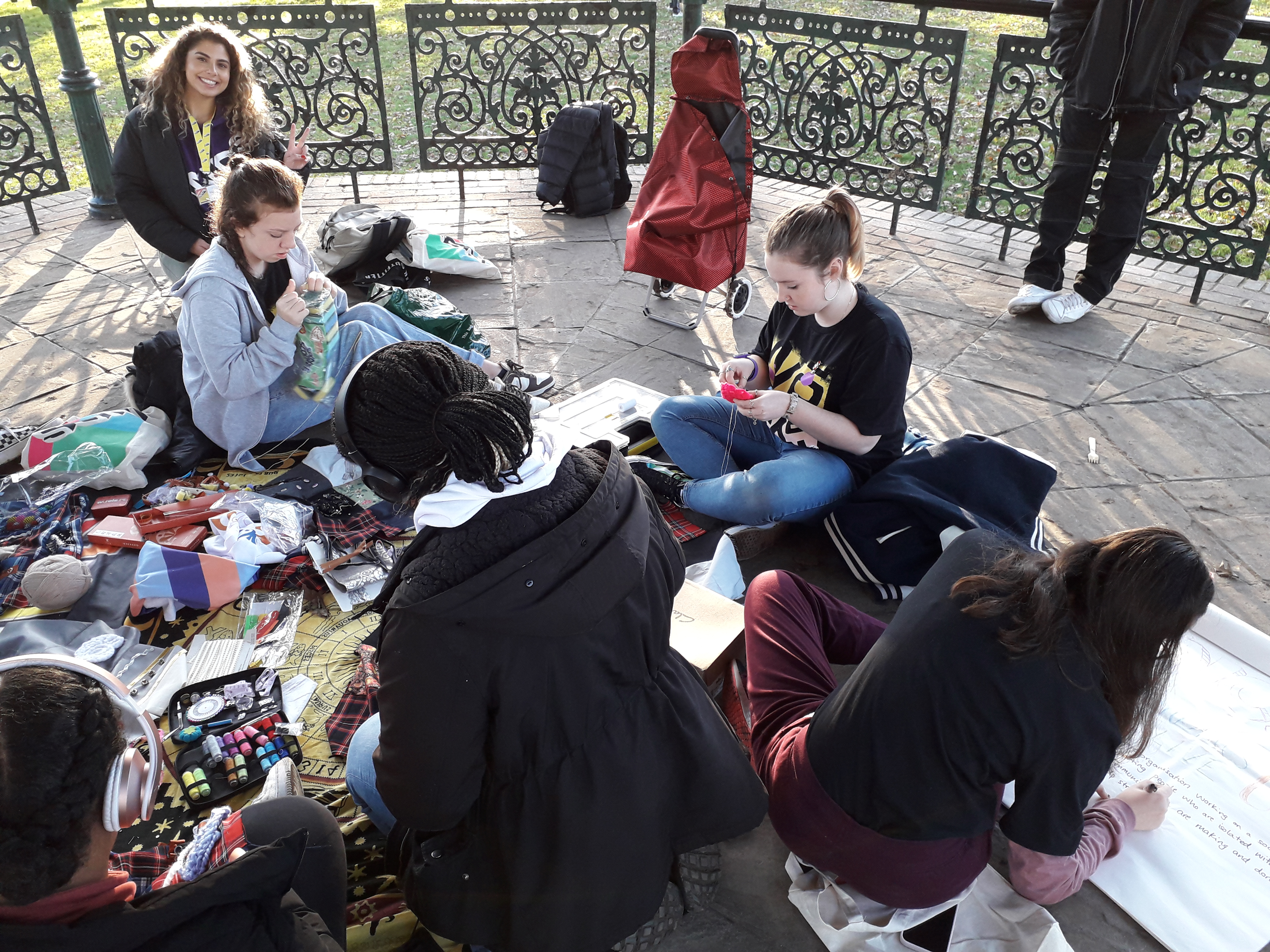 Young girls with gifts for the Superstar Dementia Fidget Blanket Project