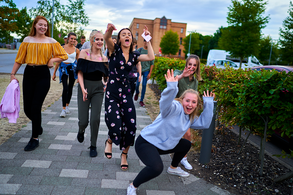 A group of young women are posing for a picture in a happy mood.