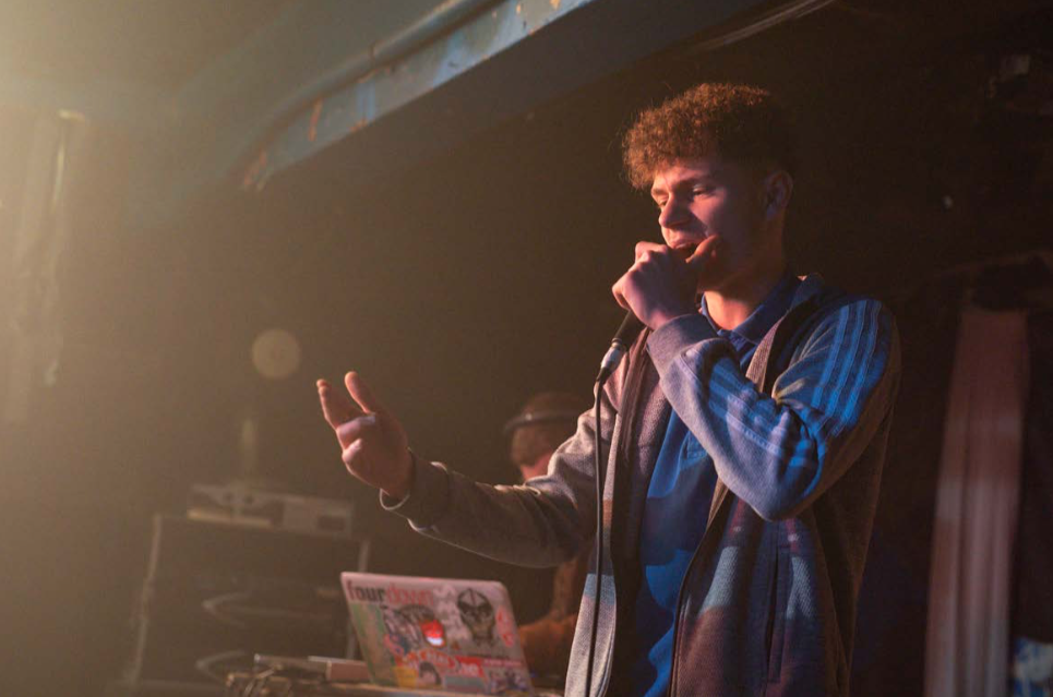 young person holding a microphone on a stage