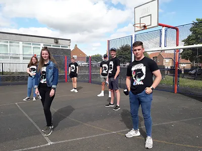 young people standing in two lines on outdoor basketball court