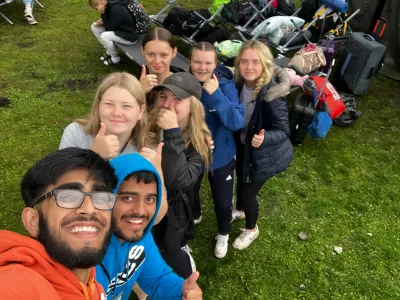 NCS team leader Uzair taking a selfie with a group of young people on their away from home experience