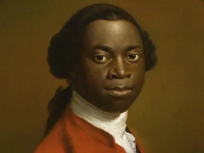 Ignatius Sancho a black man with a red coat and a white shirt in a portrait picture.