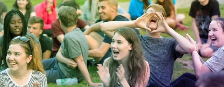 Young people sitting in the park on the grass